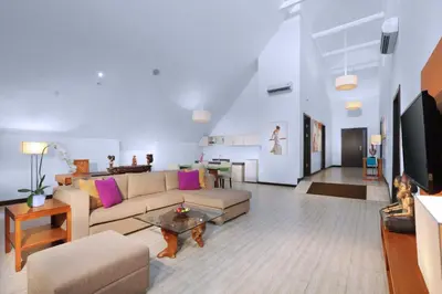 a living room with a couch and a table at Lv8 Resort Hotel in Canggu