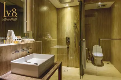 a bathroom with a sink and a shower at Lv8 Resort Hotel in Canggu