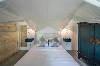 a bedroom with a large white bed with two lamps at Villa Palm Tree - Huge 4bd Villa CENTER SEMINYAK in Seminyak