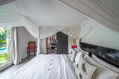 a bedroom with a white bed with a canopy at Villa Palm Tree - Huge 4bd Villa CENTER SEMINYAK in Seminyak