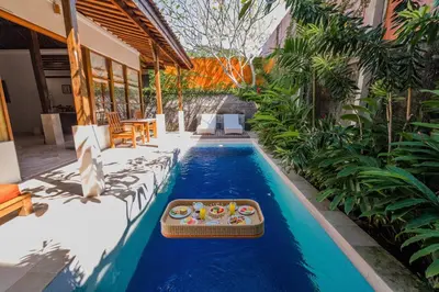 a pool with a tray of food in a house at Alam Bidadari Seminyak in Seminyak