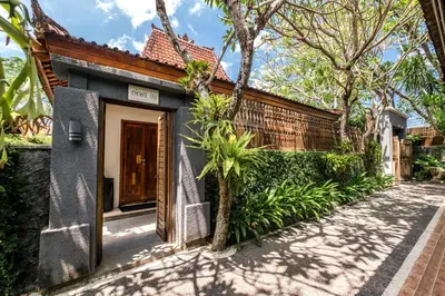 a house with a gate in front of a building at Alam Bidadari Seminyak in Seminyak