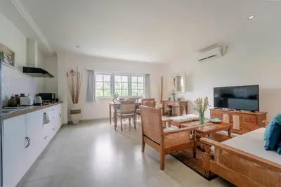 a kitchen and living room with a table and chairs at Umalas Suites in Seminyak