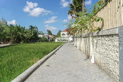 a brick sidewalk next to a stone wall at Umalas Suites in Seminyak
