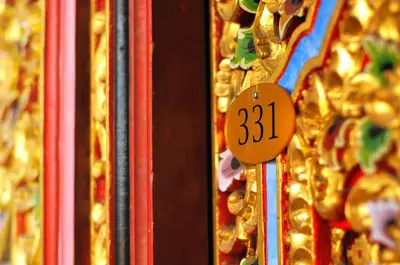 a price sign on a display of gold medals at Bemo Corner Guest House in Kuta