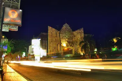 a building at night with streaks of lights in front at Bemo Corner Guest House in Kuta