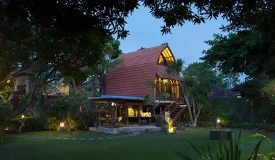 a house with a red roof with lights on it at Alindra Villas & Spa in Nusa Dua