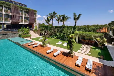 a swimming pool with lounge chairs and a resort at Four Points by Sheraton Bali, Seminyak in Seminyak