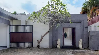 a building with a tree in front of a door at Villa Harmony Canggu in Canggu