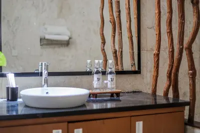 a bathroom counter with a sink and a mirror at Villa Harmony Canggu in Canggu
