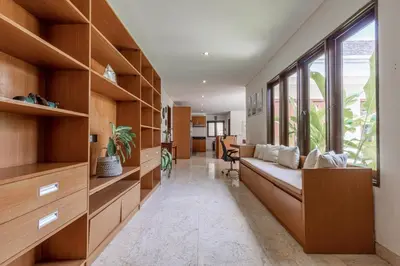 a living room with a couch and a large window at Villa Harmony Canggu in Canggu