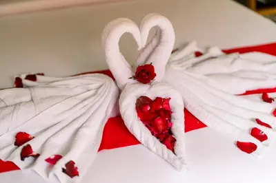 two swans shaped like hearts on a bed at Taman Bali Villas Dewi Sri in Legian
