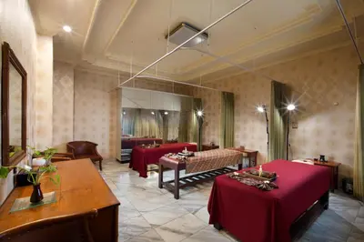 a restaurant with red tables and chairs and a mirror at Grand Istana Rama Hotel in Kuta