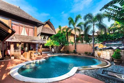 a swimming pool in front of a house at Nipper Villa - Spacious 4BR in Canggu in Canggu