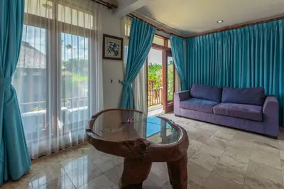 a living room with a couch and a glass table at Nipper Villa - Spacious 4BR in Canggu in Canggu