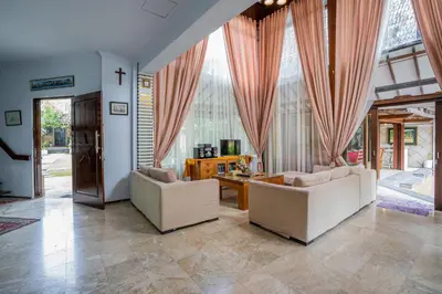 a living room with two couches and a table at Nipper Villa - Spacious 4BR in Canggu in Canggu