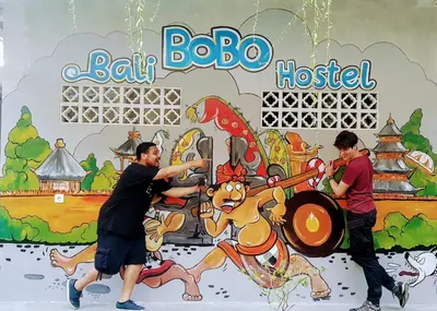 a group of people playing a game on a wall at Bali Bobo Hostel in Jimbaran