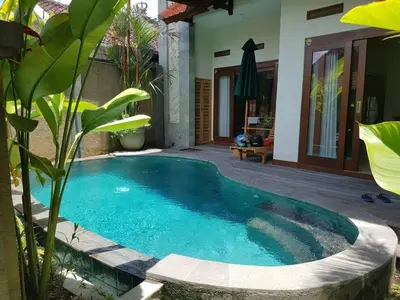 a swimming pool in the middle of a yard at Villa Rahayu in Seminyak