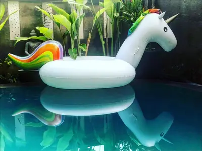 a inflatable unicorn sitting on top of a swimming pool at Villa Rahayu in Seminyak