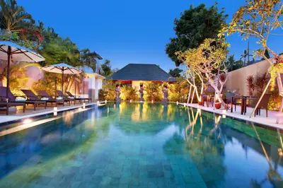 a swimming pool at a resort at night at New Pondok Sara Villas in Seminyak