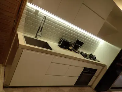 a kitchen with a sink and a counter top at Villa Hujan in Seminyak