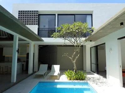 a house with a swimming pool in front of it at Villa Hujan 2 in Seminyak