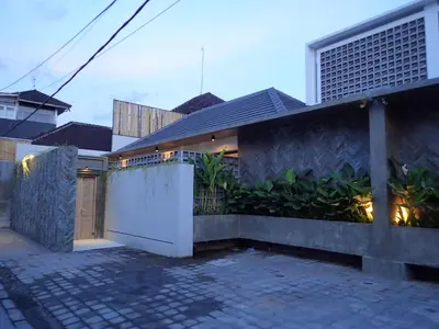a house with a white gate and a fence at Villa Hujan 2 in Seminyak