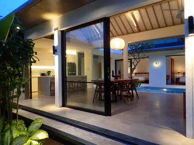an open patio with a dining area and a dining table at Villa Hujan 2 in Seminyak