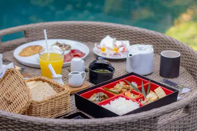 a table with a tray of food and drinks on it at DISINI Luxury Spa Villas-CHSE Certified in Seminyak