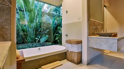a bathroom with a bath tub and a fish tank at DISINI Luxury Spa Villas-CHSE Certified in Seminyak