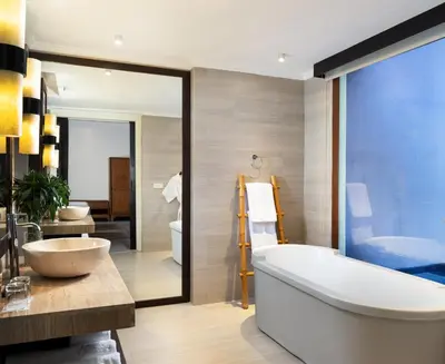 a bathroom with a tub and a sink at Avani Seminyak Bali Resort in Seminyak