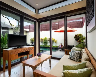 a living room with a tv and a couch at Avani Seminyak Bali Resort in Seminyak