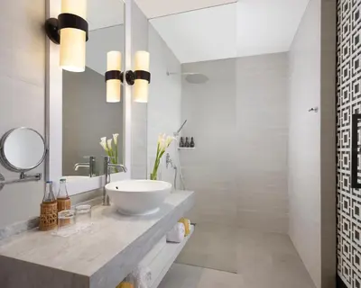 a bathroom with a sink and a mirror at Avani Seminyak Bali Resort in Seminyak