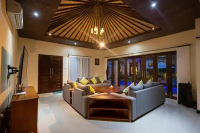 a living room with a couch and a table at Villa Katara in Seminyak