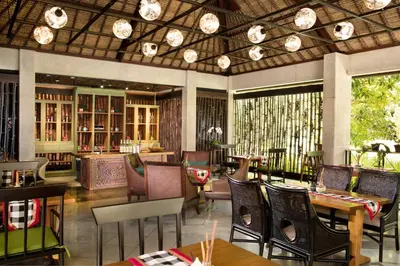 a restaurant with tables and chairs in a room at AYANA Resort Bali in Jimbaran