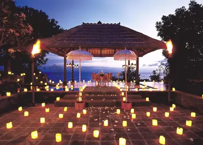 a group of candles on a patio with a gazebo at AYANA Resort Bali in Jimbaran