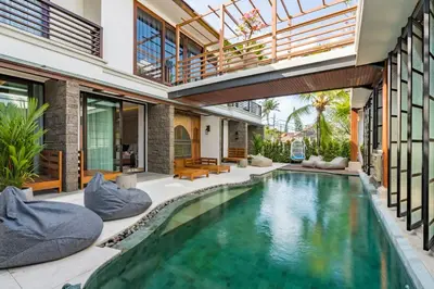 an indoor pool in a villa with a house at The Akasha Seminyak Bali Boutique Hotel in Seminyak