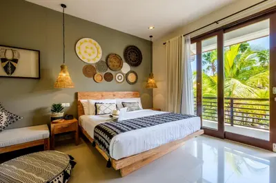 a bedroom with a bed and a large window at The Akasha Seminyak Bali Boutique Hotel in Seminyak