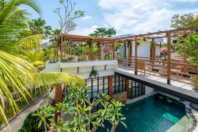 a house with a swimming pool and a balcony at The Akasha Seminyak Bali Boutique Hotel in Seminyak