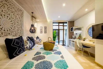 a living room with a couch with pillows on it at The Akasha Seminyak Bali Boutique Hotel in Seminyak