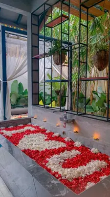 a large arrangement of red and white flowers in a room at Vinna Villa Seminyak by The Wina Resorts in Kerobokan