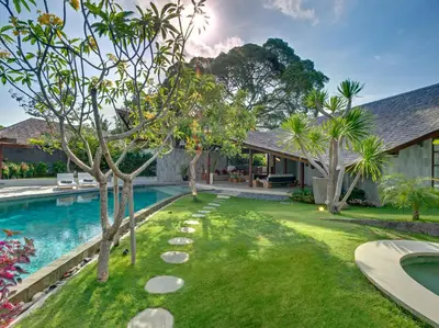 an image of a backyard with a swimming pool and trees at The Layar - Designer Villas and Spa in Seminyak