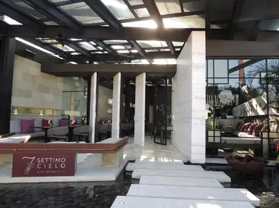 a lobby with a restaurant with tables and chairs at The Layar - Designer Villas and Spa in Seminyak