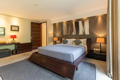 a bedroom with a bed and a desk at The Layar - Designer Villas and Spa in Seminyak