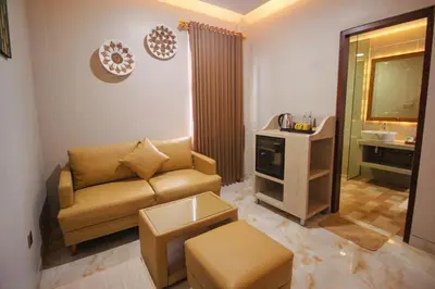 a living room with a couch and a sink at Kuta Majesty Hotel in Legian
