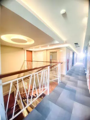 a hallway with a staircase in a building at Kuta Majesty Hotel in Legian