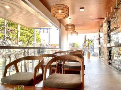 a row of chairs and tables in a restaurant at Kuta Majesty Hotel in Legian
