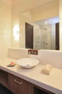 a bathroom with a sink and a large mirror at Destiny Villas and Residence in Seminyak