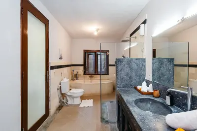 a bathroom with a sink and a toilet and a tub at MAHAYANA VILLA - 7Min Beach Access - 10min to Canggu in Canggu