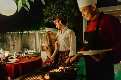 a man and a woman standing in front of a grill at Berry Amour Romantic Villas in Seminyak